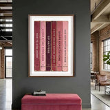 Framed artwork of book spines on a gray wall in a modern interior setting.