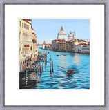 A framed art print depicting a scenic view of the Grand Canal in Venice, featuring colorful buildings, gondolas on the water, and the Santa Maria Basilica in the background under a clear blue sky.