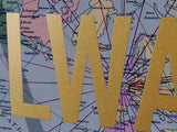 Gold letters 'LWA' on a map background