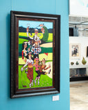 Framed artwork of cartoon characters on a blue wall