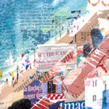 A close-up collage of beach and seaside imagery, including blue water, sandy shore, small figures, buildings, and newspaper text, with no single physical product clearly isolated.
