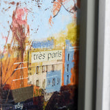 cityscape artwork with the text 'tres paris' framed in white
