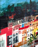 A close-up of a colorful abstract painting or art print showing stylized buildings, trees, and bold brushstrokes in red, yellow, black, blue, and white, with part of a white frame or border visible on the left.