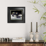 Framed still life artwork of blackberries on a wall above a wooden console table with decor items.