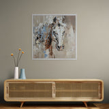 Framed abstract painting of a horse on a wall above a wooden console table.
