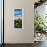 Framed artwork of a landscape with flowers on a wall in a modern interior setting.