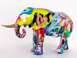 Colorful elephant sculpture with graffiti-style design on a white background