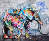 Colorful graffiti-style elephant painting on a textured wall with 'Stand Tall' text.