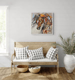 A framed abstract painting of a horse in warm earthy tones room