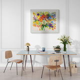 Dining room with a table, chairs, and a colourful floral painting on the wall.