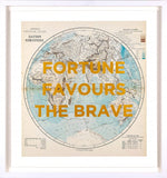 A framed vintage-style world map print featuring the text 'FORTUNE FAVOURS THE BRAVE' in large yellow letters over a light blue and beige globe design, shown in a white frame against a white background.