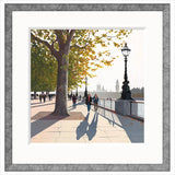 Framed artwork of a cityscape with people walking along a path by trees and street lamps. Jo Quigley limited edition art
