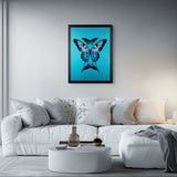 A framed wall art print featuring a blue butterfly on a bright turquoise background, displayed above a white sofa in a modern living room setting.