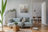 Framed art of a hare in a field hanging in a living room