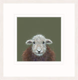 A framed art print featuring a close-up illustration of a sheep's face and upper body against a muted olive green background, presented with a wide white mount and light wood frame.