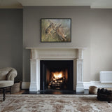 Two hares boxing in long grass hung over fire place