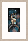 A framed art print featuring a whimsical illustration of a cottage on a stone bridge under a starry night sky, presented with a light wood frame.