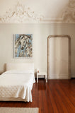 a framed horse painting on the wall